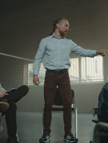 A group therapy session indoors with diverse adults engaging in discussion and support.